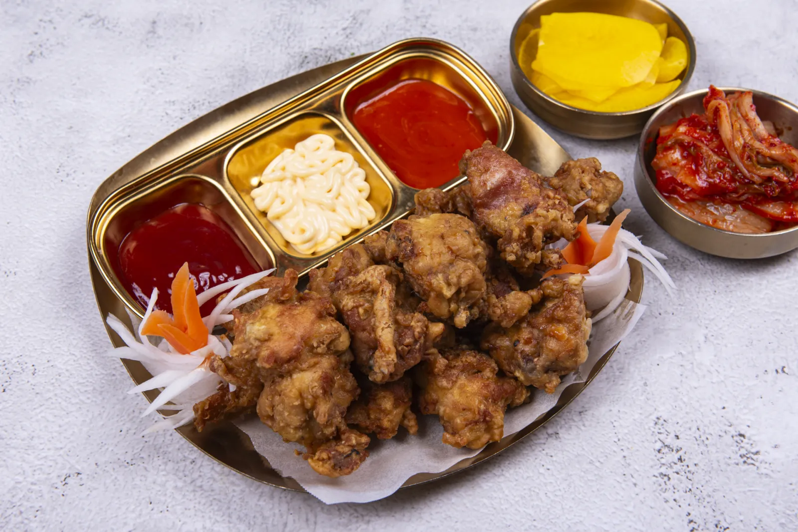 Korean fried chicken on a gold platter