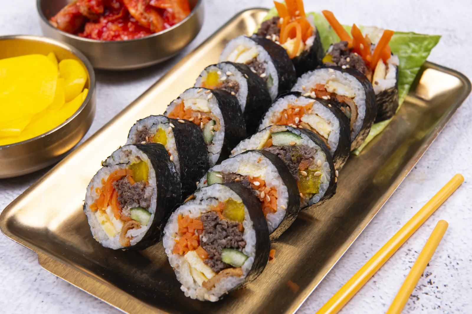 Bulgogi gimbap seaweed rice rolls on a gold tray