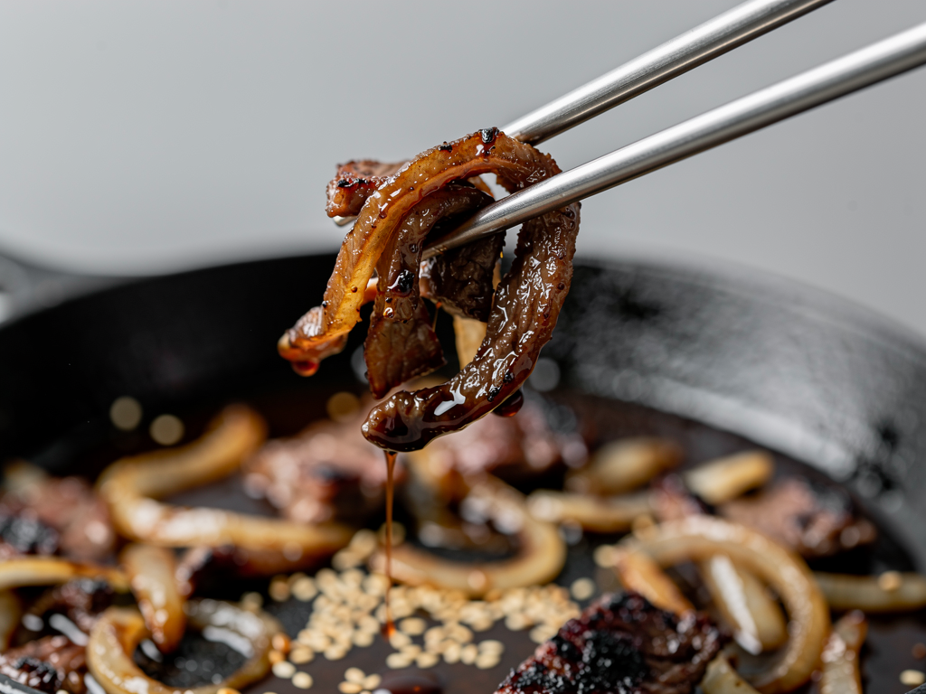 Thin slices of caramelised Korean bulgogi beef lifted from the pan in Dubai