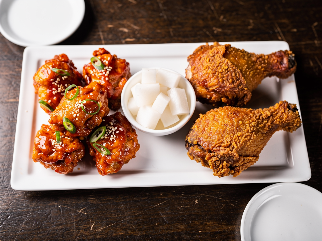 Korean Food vs American Food (2026): The Honest UAE Guide 2 Korean fried chicken in red yangnyeom sauce next to American fried chicken