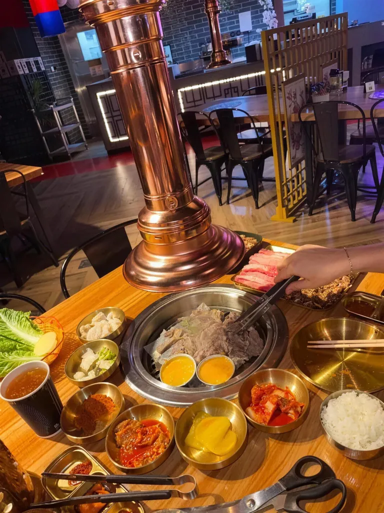 Mukbang Shows — New Homepage 10 Copper grill table at Mukbang Shows JBR set with banchan, lettuce wraps and sauces